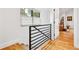 Staircase with modern metal railing, wood stairs, and natural light from window at 1690 Spruce St, Denver, CO 80220