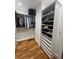 Organized walk-in closet with custom shelves for clothing and shoes at 1690 Spruce St, Denver, CO 80220