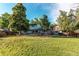 Large backyard with ample lawn, deck, and mature trees providing a perfect outdoor living and entertaining space at 11682 E Iowa Ave, Aurora, CO 80012