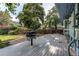 Spacious backyard featuring an expansive deck and mature trees creating a peaceful outdoor setting at 11682 E Iowa Ave, Aurora, CO 80012