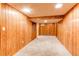 Finished basement featuring carpet flooring and wood panel walls at 11682 E Iowa Ave, Aurora, CO 80012