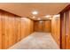 Spacious basement featuring carpet flooring and wood panel walls at 11682 E Iowa Ave, Aurora, CO 80012