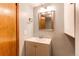 Simple bathroom featuring a modern vanity and neutral gray walls offering a clean, updated look at 11682 E Iowa Ave, Aurora, CO 80012