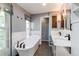 Modern bathroom showcasing a soaking tub, double vanity, and stylish fixtures at 11682 E Iowa Ave, Aurora, CO 80012