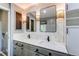 Elegant bathroom boasting a double vanity with marble countertop and decorative lighting at 11682 E Iowa Ave, Aurora, CO 80012