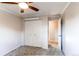 Bedroom with neutral walls, carpet, closet and adjacent doorway at 11682 E Iowa Ave, Aurora, CO 80012