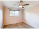 Cozy bedroom featuring a ceiling fan and a window allowing natural light at 11682 E Iowa Ave, Aurora, CO 80012