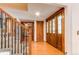 Spacious foyer with hardwood floors, decorative wood door, closet and staircase with metal spindles at 11682 E Iowa Ave, Aurora, CO 80012