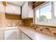 Well-lit laundry room with a sink, counter space, and decorative backsplash at 11682 E Iowa Ave, Aurora, CO 80012