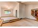 Spacious living room with vaulted ceilings, large windows, and a staircase with metal spindles, offering a bright interior at 11682 E Iowa Ave, Aurora, CO 80012