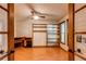 Bright office space with built-in shelving, a ceiling fan, hardwood floors, and a window at 11682 E Iowa Ave, Aurora, CO 80012
