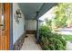 Covered porch with stone accents and fresh landscaping, offering a welcoming entrance to the home at 11682 E Iowa Ave, Aurora, CO 80012
