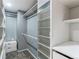 Bright, well-organized walk-in closet featuring ample shelving and storage space at 11682 E Iowa Ave, Aurora, CO 80012