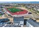 An aerial view showcases modern townhomes near a vibrant athletic field at 2446 W 167Th Ln, Broomfield, CO 80023