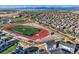 An aerial view displays townhomes close to a vibrant athletic field in a Primary-planned community at 2446 W 167Th Ln, Broomfield, CO 80023