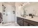 Stylish bathroom with double vanity, modern fixtures, and a walk-in shower, offering a luxurious and functional space at 2446 W 167Th Ln, Broomfield, CO 80023