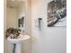 Modern powder room displaying a pedestal sink, neutral wall tones, and elegant decor at 2446 W 167Th Ln, Broomfield, CO 80023
