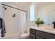 Well-lit bathroom with white subway tile, dark vanity, and a plant, creating a serene atmosphere at 2446 W 167Th Ln, Broomfield, CO 80023