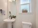 Well-lit half bathroom with a pedestal sink, stylish fixtures, and a clean design, offering a functional space at 2446 W 167Th Ln, Broomfield, CO 80023