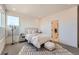 Comfortable bedroom with soft bedding, neutral colors, and a view to an attached bathroom, providing a peaceful retreat at 2446 W 167Th Ln, Broomfield, CO 80023
