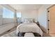 Bright bedroom featuring large windows, neutral decor, and comfortable furnishings, creating a relaxing and inviting retreat at 2446 W 167Th Ln, Broomfield, CO 80023