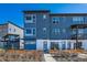 Contemporary three-story townhome with a blue exterior and a well-manicured front yard at 2446 W 167Th Ln, Broomfield, CO 80023