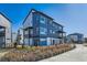 Striking blue townhome exterior with modern architectural details and manicured landscaping at 2446 W 167Th Ln, Broomfield, CO 80023