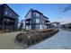 Townhome exterior features a modern design with balcony and landscaped front yard at 2446 W 167Th Ln, Broomfield, CO 80023