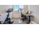 Inviting home office space with a Peloton bike, modern desk, and large window for ample natural light at 2446 W 167Th Ln, Broomfield, CO 80023
