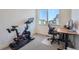 Inviting home office space with exercise bike, modern desk, and large window providing natural light at 2446 W 167Th Ln, Broomfield, CO 80023