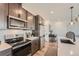 Modern kitchen featuring stainless steel appliances, sleek cabinets, and stylish backsplash, creating a functional and appealing space at 2446 W 167Th Ln, Broomfield, CO 80023