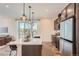 Bright kitchen with a large window, modern pendant lights, stainless steel appliances, and a spacious countertop at 2446 W 167Th Ln, Broomfield, CO 80023