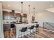 Modern kitchen island with seating, stainless steel appliances, and decorative lighting at 2446 W 167Th Ln, Broomfield, CO 80023