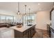 Modern kitchen with stainless steel appliances, and stylish bar seating overlooking the living room at 2446 W 167Th Ln, Broomfield, CO 80023