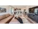 Open-concept living room showcasing kitchen, island with seating, and stylish modern design at 2446 W 167Th Ln, Broomfield, CO 80023