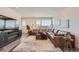 Bright living room with large window, tv and modern fireplace, and comfortable sectional sofa at 2446 W 167Th Ln, Broomfield, CO 80023