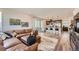 Open concept living room and kitchen with a large leather sectional sofa and modern appliances at 2446 W 167Th Ln, Broomfield, CO 80023