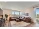 Spacious living room with large window, balcony access, and comfortable sectional sofa at 2446 W 167Th Ln, Broomfield, CO 80023
