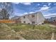 Spacious backyard with a well-maintained lawn, surrounded by wood fences at 5587 S Simms Way, Littleton, CO 80127