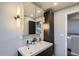 Updated bathroom features double sinks, modern lighting, and vanity storage at 5587 S Simms Way, Littleton, CO 80127