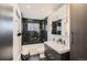 Modern bathroom featuring black tile, a double sink vanity, and updated fixtures at 5587 S Simms Way, Littleton, CO 80127