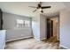 Bright bedroom boasts hardwood floors, a ceiling fan, and natural light from a window at 5587 S Simms Way, Littleton, CO 80127