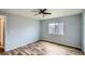 Bedroom featuring wood look floors, ceiling fan, and a window at 5587 S Simms Way, Littleton, CO 80127