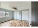 Bright bedroom with wood floors, ceiling fan, and a large window at 5587 S Simms Way, Littleton, CO 80127