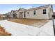 Backyard of home showing the patio and rear exterior of the home at 9693 Ceylon St, Commerce City, CO 80022
