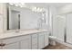 Bright bathroom featuring a double vanity, quartz countertops, and a glass-enclosed shower at 9693 Ceylon St, Commerce City, CO 80022