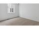 This bedroom has neutral carpet, white walls, and a window with a view of the neighborhood at 9693 Ceylon St, Commerce City, CO 80022