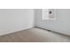 This bedroom has neutral carpet, white walls, and a window with a view of the neighborhood at 9693 Ceylon St, Commerce City, CO 80022