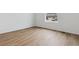 Bedroom with wood floors, white walls, and a window with a view of the neighborhood at 9693 Ceylon St, Commerce City, CO 80022