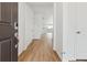 Bright hallway features hardwood floors leading to an open-concept living space at 9693 Ceylon St, Commerce City, CO 80022